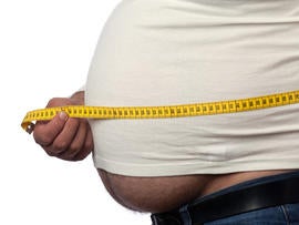 Measuring tape on large built man belly