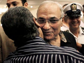 Egyptian presidential runoff candidate Ahmed Shafiq is greeted by a supporter after attending a press conference in Cairo June 8, 2012.
