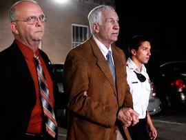 Former Penn State assistant football coach Jerry Sandusky leaves the Centre County Courthouse in handcuffs after a jury found him guilty in his sex abuse trial June 22, 2012, in Bellefonte, Pa.