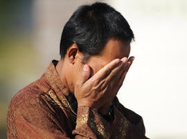 Imam Lahmuddin holds his hands over his face after a fire destroyed the Islamic Society of Joplin, Mo., mosque, Monday, Aug. 6, 2012, in Joplin, Mo.