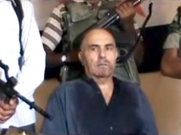 An image from an amateur video released by the Shaam News Network purports to show Syrian Pilot Colonel Rafik Mohammed Suleiman being interrogated by rebel officers after his Soviet-made MiG warplane was apparently hit by ground fire over Deir el-Zour province, an area near the Iraqi border, Syria, Monday Aug. 13, 2012.