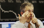 A trader wipes his eye at the Frankfurt Stock Exchange in Germany. 