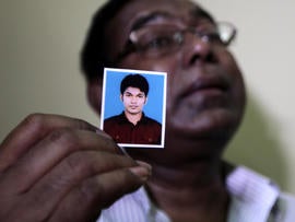 Bangladeshi Quazi Ahsanullah displays a photograph of his son, Quazi Mohammad Rezwanul Ahsan Nafis, as he weeps in his home in the Jatrabari neighborhood in north Dhaka, Bangladesh, Oct. 18, 2012.
