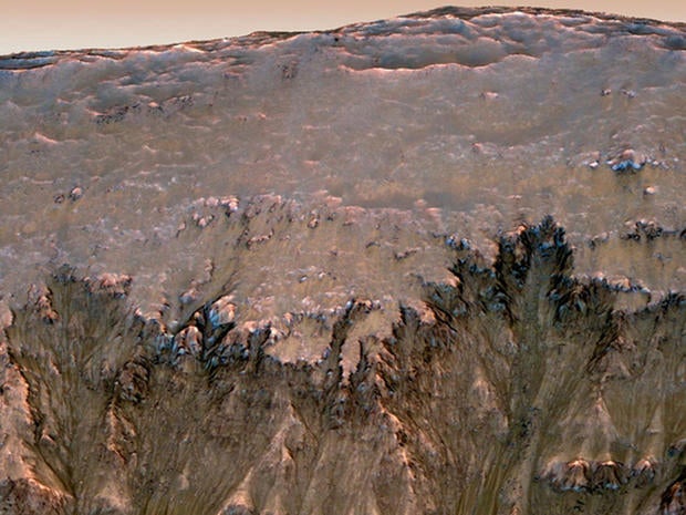 This image combining orbital imagery with 3-D modeling shows flows that appear in spring and summer on a slope inside Mars' Newton crater.