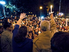 Ole Miss Chancellor Dan Jones, right, and others raise their candles during the "We are One Mississippi" candlelight walk on the campus of the University of Mississippi in Oxford, Miss., Nov. 7, 2012. The walk was organized to condemn an election night protest against the re-election of President Obama.