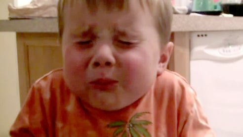 Young boy eats his first Atomic Warhead sour candy - CBS News