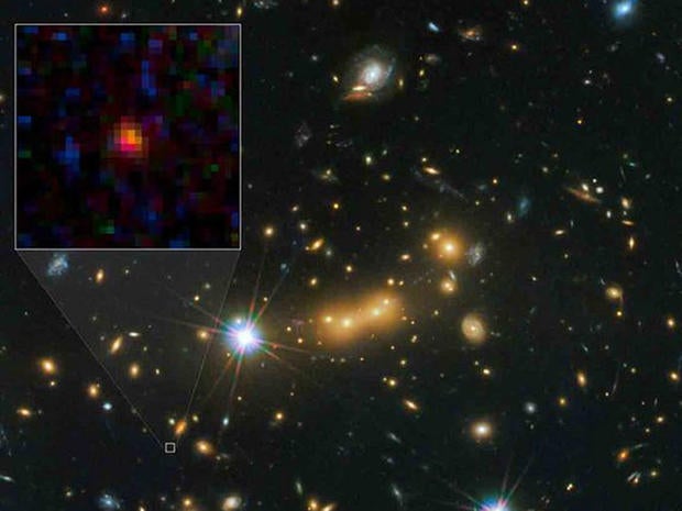 The galaxy MACS0647-JD (inset) appears very young and is only a fraction of the size of our own Milky Way. The galaxy is about 13.3 billion light-years from Earth, the farthest galaxy yet known, and formed 420 million years after the Big Bang.
