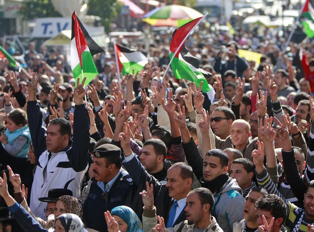 People wave Palestinian flags during a rally supporting the Palestinian UN bid for observer state status, in the West bank city of Ramallah, Thursday, Nov. 29, 2012.