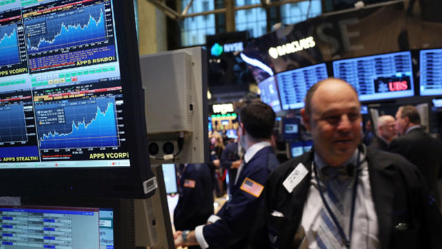 A trader smiles on Jan. 2, 2013, on the trading floor of the New York Stock Exchange in New York. 