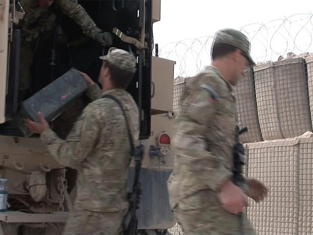 U.S. soldiers load boxes onto a truck as they prepare to leave Combat Outpost Timothy Johnson