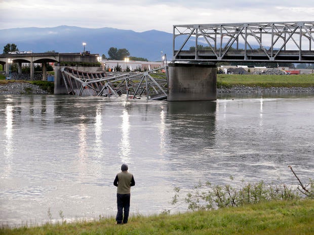 A person looks from the south bank of the Skagit River across to the collapsed portion of the Interstate 5 bridge May 24, 2013, in Mount Vernon, Wash.