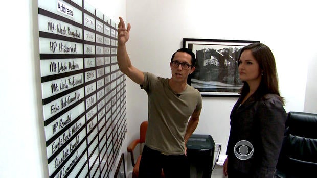 Matt Manner shows the production board in his office that lists all the homes he is flipping.