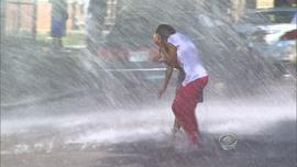 A child find relief from triple-digit weather in Chicago by running through water on July 17, 2013.