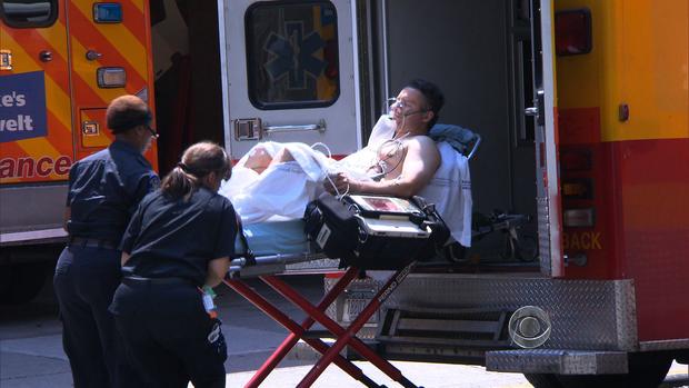EMT workers with St. Luke's-Roosevelt hospital attend to a man during a brutal heat wave in New York City July 17, 2013.