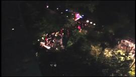 An aerial view of emergency officials responding to where a bus carrying Italian pilgrims plunged off a highway and into a ravine outside Naples Sunday, July 28, 2013.