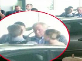 Edward Snowden, back to camera, inset closeup, is seen leaving Moscow's Sheremetyevo airport after Russia granted him temporary asylum Aug. 1, 2013.