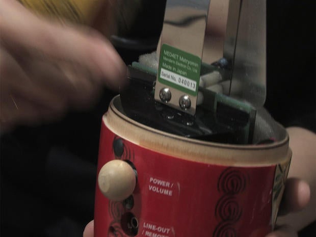 A Japanese musician shows the inside of a "matryomin"