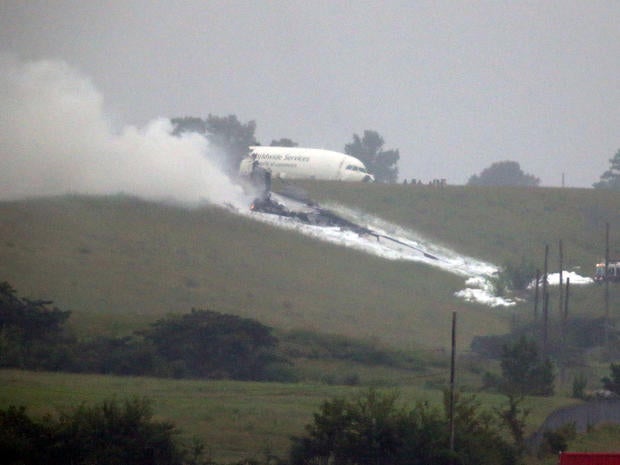 A UPS cargo plane lies on a hill at Birmingham-Shuttlesworth International Airport after crashing on approach Aug. 14, 2013, in Birmingham, Ala.