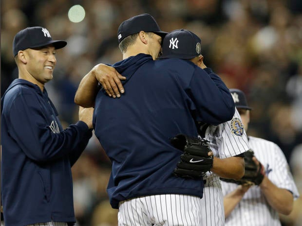 New York Yankees shortstop Derek Jeter, left, watches as starting pitcher Andy Pettitte, center, embraces a sobbing Mariano Rivera on the mound in the ninth inning of Rivera's final appearance in a game at Yankee Stadium, against the Tampa Bay Rays on Sept. 26, 2013. The Rays won, 4-0.