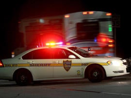 Police block the road to the Jacksonville International Airport terminal as a shuttle used to move people out of the airport drives by Tuesday, Oct. 1, 2013, in Jacksonville, Fla. The airport was evacuated after authorities found two suspicious packages.