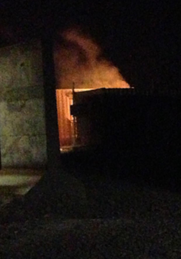 Flames come from a building after a rocket attack on Forward Operating Base Shank