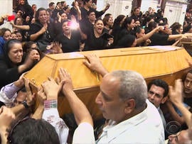 Mourners grieve for five Christians killed by masked gunmen.