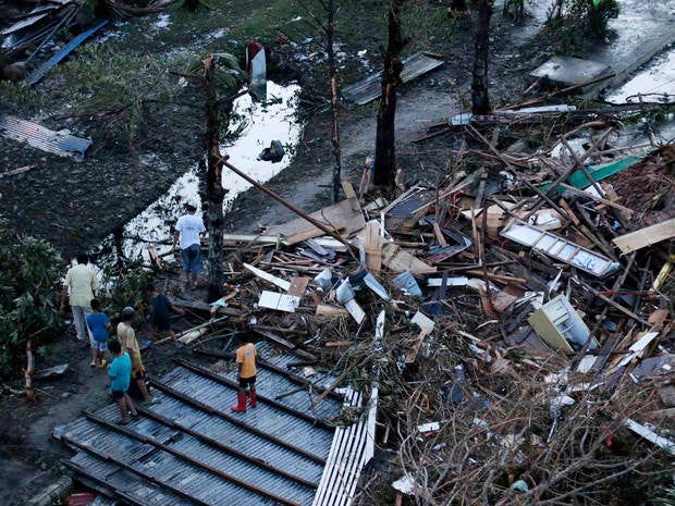 Residents sift through the rubble of their damaged house following a powerful typhoon that hit Tacloban on hardest-hit Leyte Island in the Philippines Nov. 9, 2013.