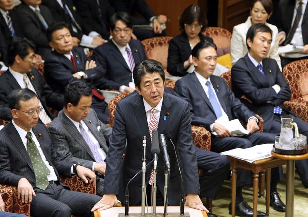 Japanese Prime Minister Shinzo Abe (C) answers a question during the Upper House's audit committee session at the National Diet in Tokyo