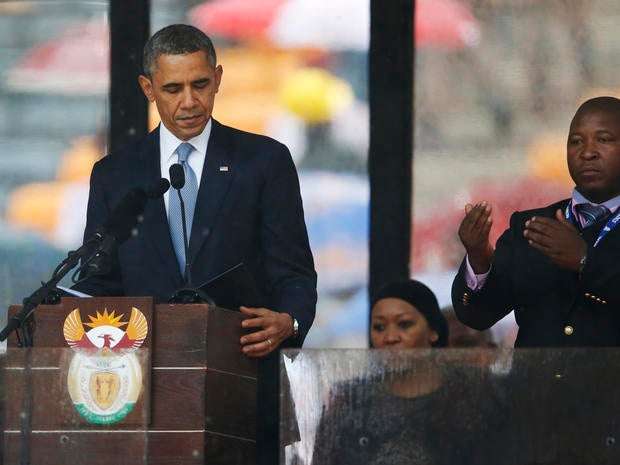 President Obama looks down as he stands next to the sign-language interpreter as he makes his speech at the memorial service for former South African President Nelson Mandela at FNB Stadium in Soweto near Johannesburg Dec. 10, 2013.