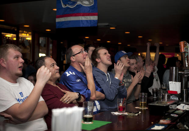 New York Football Fans Watch The Giants Against The New England Patriots In The Super Bowl 