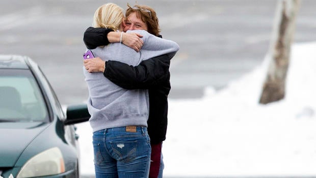 Two people embrace in the parking lot at the scene of a shooting at The Mall in Columbia Jan. 25, 2014, in Columbia, Md.