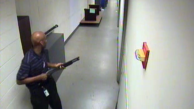 Aaron Alexis moves through the hallways of Building #197 at the Washington Navy Yard in Washington carrying a Remington 870 shotgun Sept. 16, 2013, in this handout framegrab provided by the FBI.