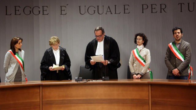 Judge Alessandro Nencini, center, reads the verdict during the retrial of Raffaele Sollecito and Amanda Knox for the murder of British student Meredith Kercher at the courthouse in Florence, Italy, Jan. 30, 2014. 
