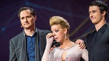 Dancer Adrianne Haslet-Davis, center, wipes away a tear while standing on stage with MIT professor Hugh Herr, left, and dancer Christian Lightner at the 2014 TED Conference March 19, 2014, in Vancouver, British Columbia, in this picture provided by TED 20