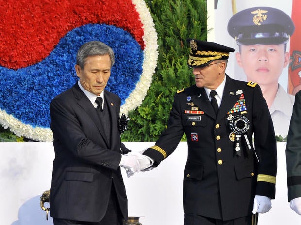 South Korean Defence Minister Kim Kwan-Jin (L) shakes hand with General Curtis Scaparrotti, commander of U.S. Forces Korea