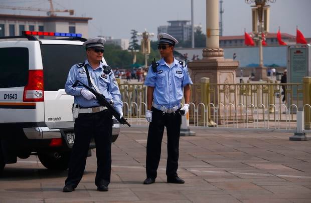 Armed police stand guard at Tiananmen Square in Beijing