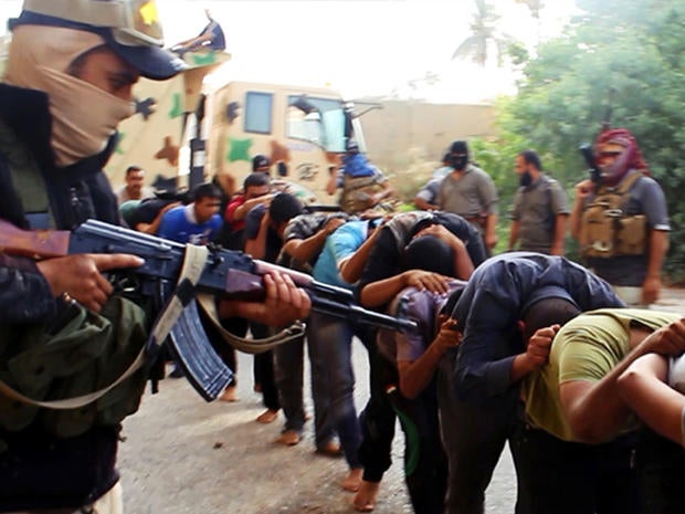 This image posted on a militant website June 14, 2014, which has been verified appears to show militants from the al-Qaeda-inspired Islamic State of Iraq and Syria (ISIS) leading away captured Iraqi soldiers dressed in plain clothes after taking over a ba