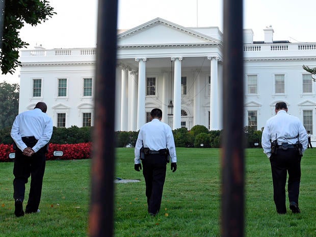 Uniformed Secret Service officers walk along the lawn on the North side of the White House in Washington Sept. 20, 2014.