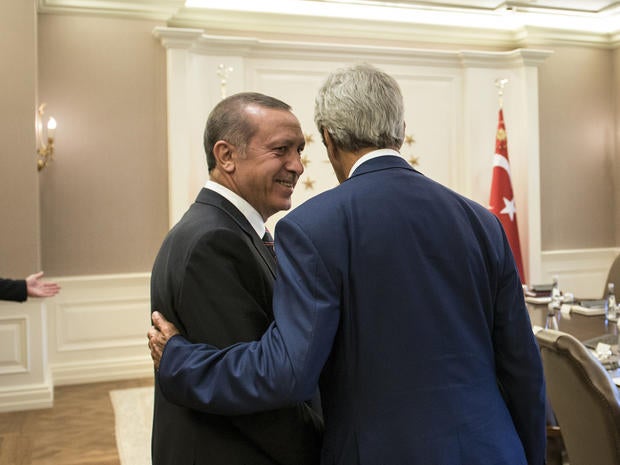 Turkish President Recep Tayyip Erdogan speaks with Secretary of State John Kerry