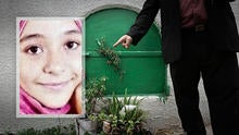 A man stands Nov. 5, 2014, in front of the grave of 13-year-old Suheir El-Batea, inset, who died undergoing the procedure of female genital mutilation performed by Dr. Raslan Fadl, in Dierb Biqtaris village, on the outskirts of the town of Aga in Dakahli