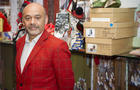 French shoe designer Christian Louboutin poses for photographers as he opens his first-ever retrospective exhibition at the Design Museum in London April 30, 2012. 