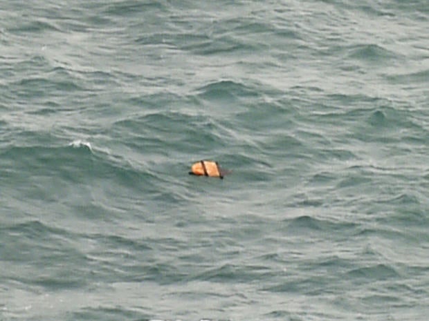 Aerial view taken from Indonesian search and rescue aircraft over Java Sea shows floating debris spotted in same area as other items being investigated by Indonesian authorities as possible objects from missing AirAsia Flight 8501 on December 30, 2014