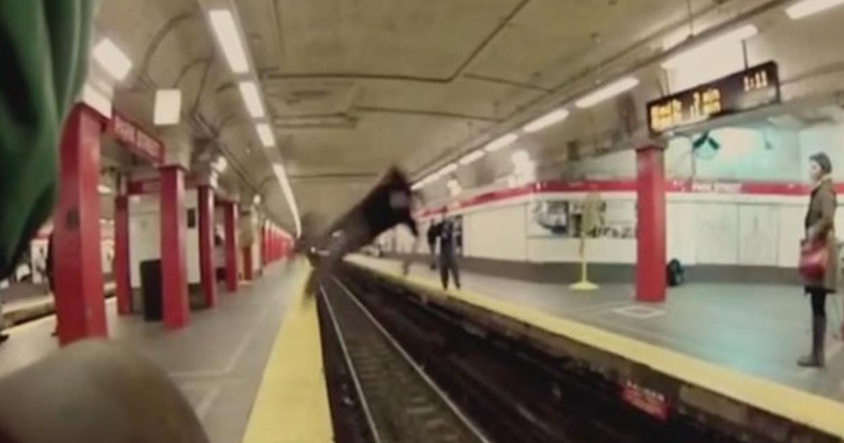 Video shows man's daring flip over Boston subway tracks - CBS News