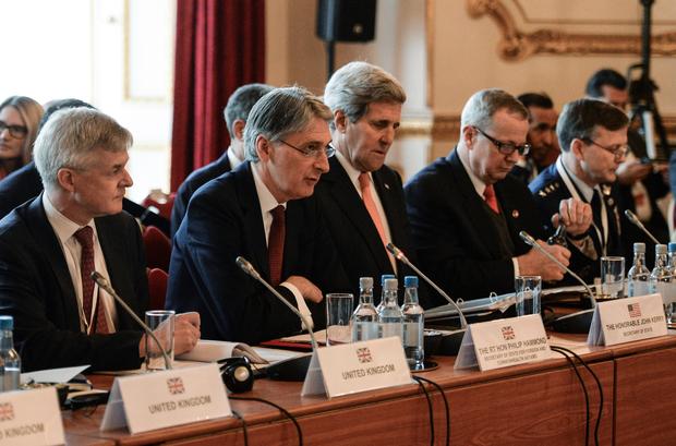 British Foreign Secretary Philip Hammond (2L) and US Secretary of State John Kerry (3L) co-host a meeting of members of an anti-Islamic State coalition (IS) at Lancaster House in London Jan. 22, 2015.