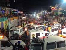 Emergency service vehicles and personnel attend the scene of a fatal accident during a Carnival float procession in Port-au-Prince