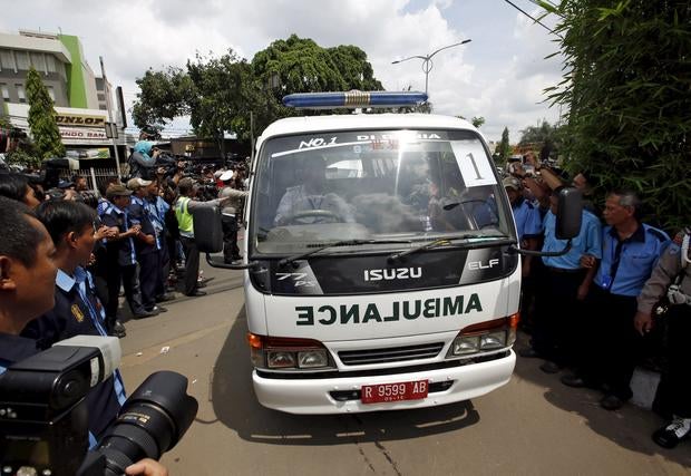 An ambulance carrying one of the bodies of two Australians who were executed earlier arrives at a funeral home in Jakarta