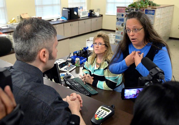 Rowan County Clerk Kim Davis, right, talks with David Moore following her office's refusal to issue marriage licenses at the Rowan County Courthouse in Morehead, Ky., Sept. 1, 2015.