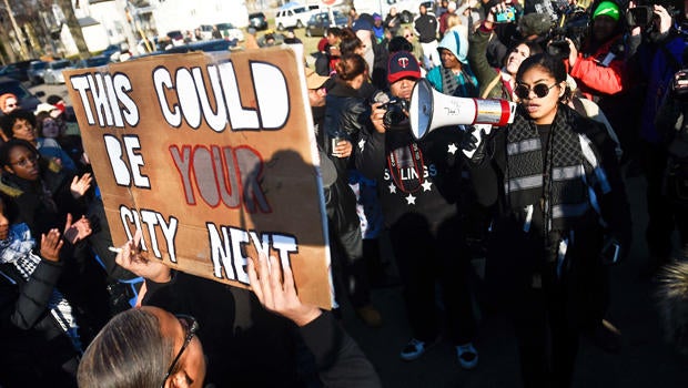 Mica Grimm, right, of Minneapolis, speaks to a gathering crowd of the group Black Lives Matter before they march to City Hall during a protest in Minneapolis, Minnesota, Nov. 24, 2015.