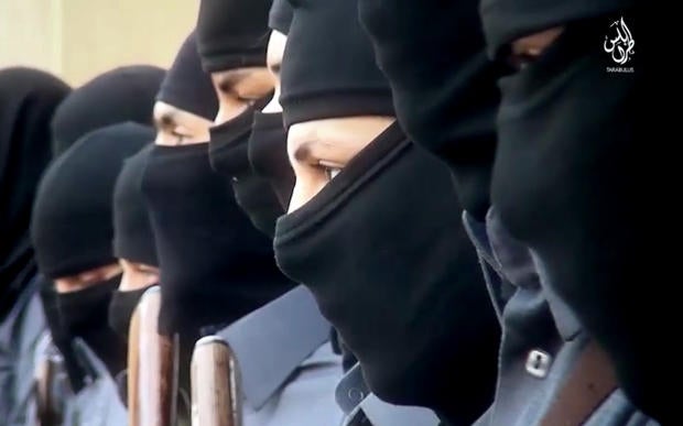 This image made from video posted online Dec. 20, 2015, by supporters of the Tripoli Province of the Islamic State of Iraq and Syria in Libya on a social media site shows training of its "Islamic police" in Sirte, Libya.