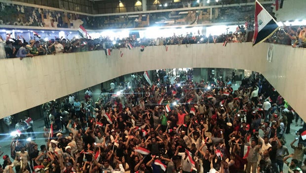 Followers of Iraq's Shiite cleric Muqtada al-Sadr are seen in the parliament building as they storm Baghdad's Green Zone after lawmakers failed to convene for a vote on overhauling the government in Iraq April 30, 2016.